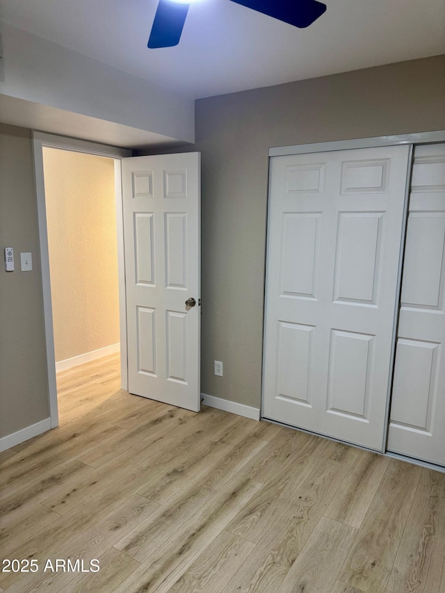 6810 N 35th Ave Unit H, Phoenix, AZ 85017 - unfurnished bedroom with light wood-style floors, a closet, baseboards, and ceiling fan