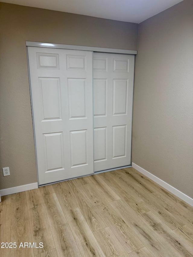 6810 N 35th Ave Unit H, Phoenix, AZ 85017 - unfurnished bedroom with light wood-type flooring, a closet, and baseboards
