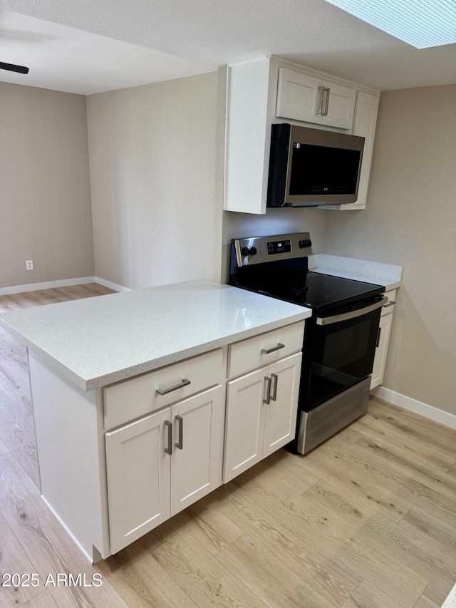 6810 N 35th Ave Unit H, Phoenix, AZ 85017 - kitchen featuring appliances with stainless steel finishes, light wood finished floors, and light stone countertops