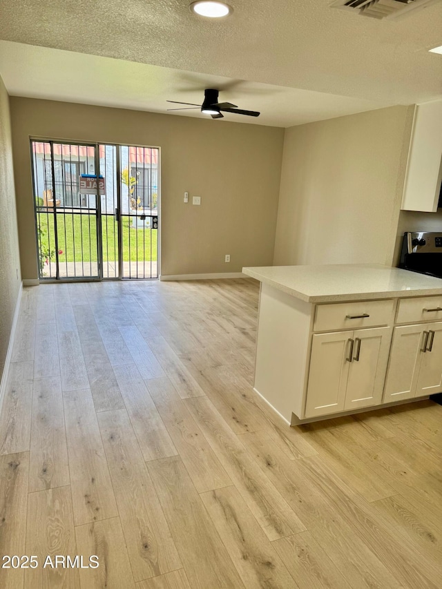 6810 N 35th Ave Unit H, Phoenix, AZ 85017 - unfurnished living room featuring a ceiling fan, baseboards, and light wood-style flooring