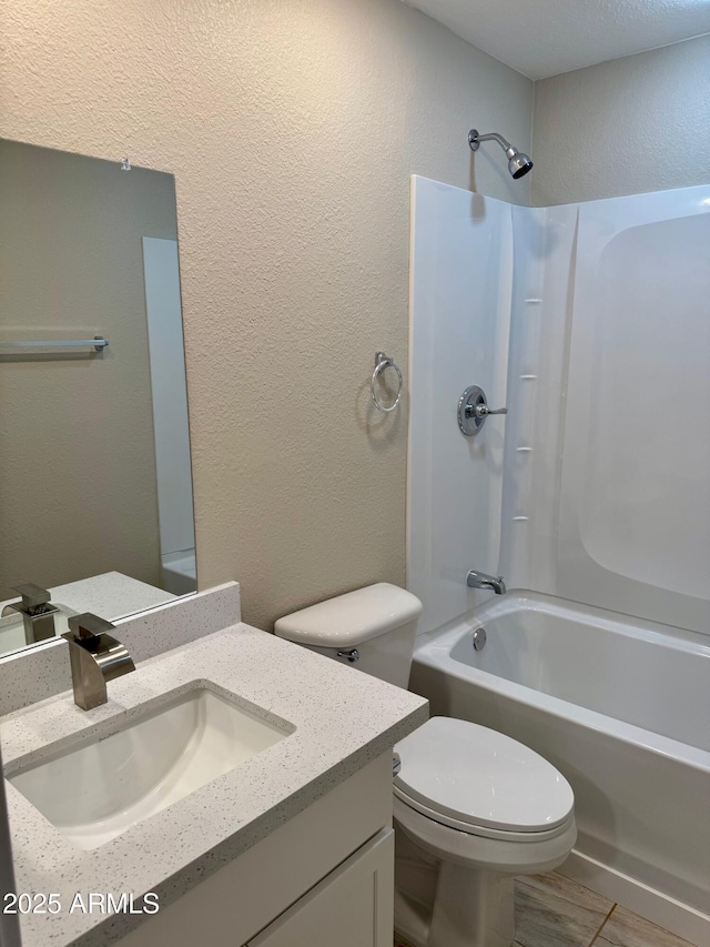 6810 N 35th Ave Unit H, Phoenix, AZ 85017 - bathroom with shower / bath combination, vanity, toilet, and a textured wall