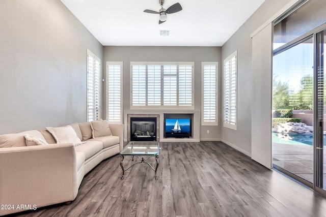 living room featuring ceiling fan and hardwood / wood-style floors