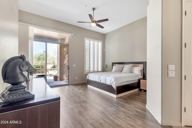 bedroom featuring ceiling fan, light wood-type flooring, and access to exterior