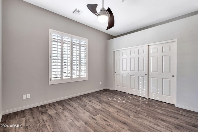 unfurnished bedroom featuring ceiling fan, a closet, and dark hardwood / wood-style floors