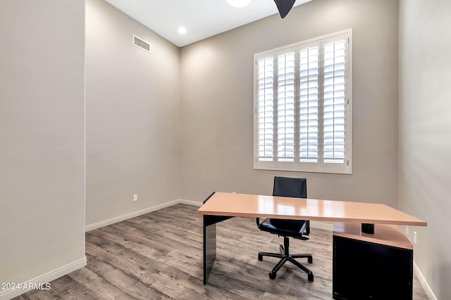 office space with wood-type flooring