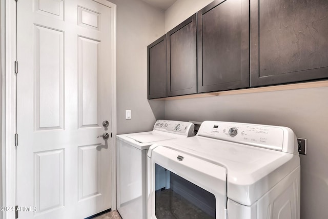 clothes washing area featuring cabinets and independent washer and dryer