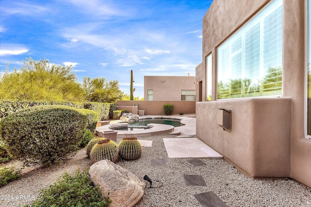 view of patio / terrace with an in ground hot tub