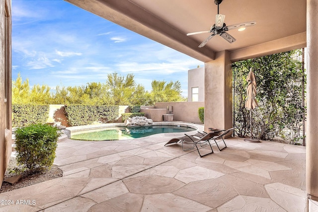 view of patio featuring ceiling fan and a fenced in pool