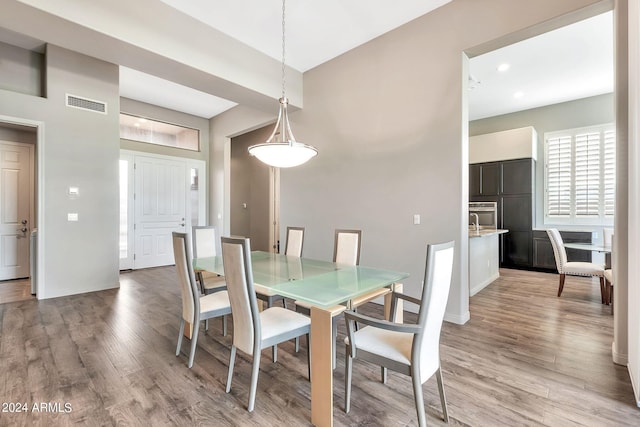 dining space with light hardwood / wood-style floors