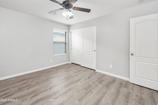 1015 E Penny Ln, San Tan Valley, AZ 85140 - unfurnished bedroom with wood finished floors, baseboards, a closet, and a ceiling fan
