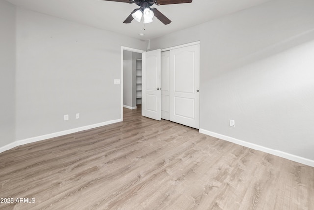 1015 E Penny Ln, San Tan Valley, AZ 85140 - unfurnished bedroom featuring baseboards, wood finished floors, a closet, and a ceiling fan