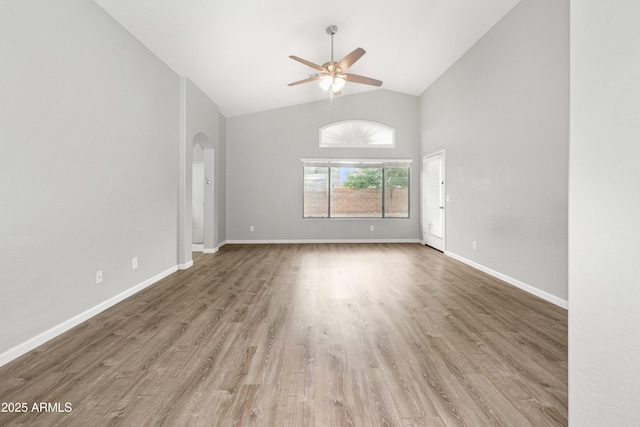 1015 E Penny Ln, San Tan Valley, AZ 85140 - unfurnished room featuring a ceiling fan, arched walkways, wood finished floors, high vaulted ceiling, and baseboards