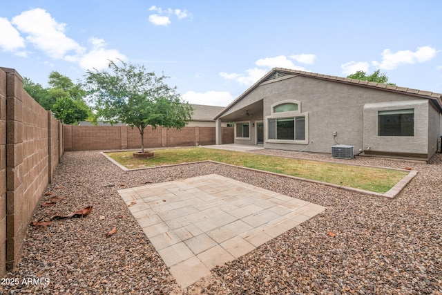 1015 E Penny Ln, San Tan Valley, AZ 85140 - back of property featuring a fenced backyard, a patio area, ceiling fan, stucco siding, and central air condition unit