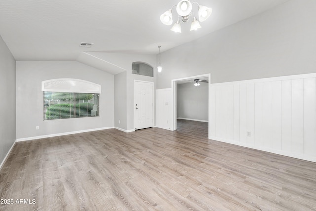 1015 E Penny Ln, San Tan Valley, AZ 85140 - spare room featuring vaulted ceiling, a chandelier, wood finished floors, wainscoting, and baseboards