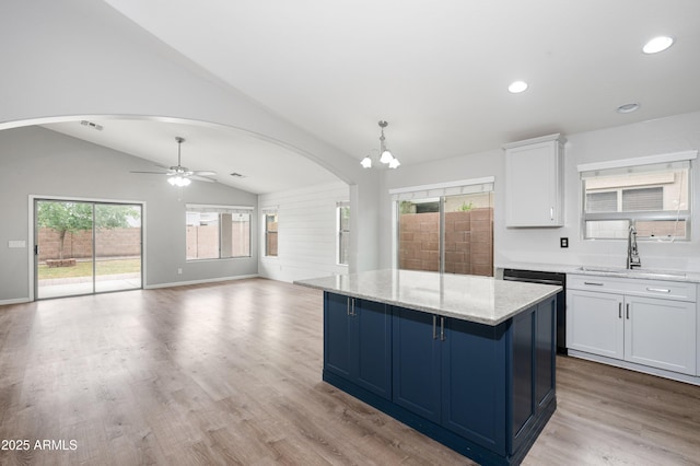 1015 E Penny Ln, San Tan Valley, AZ 85140 - kitchen featuring a sink, dishwashing machine, lofted ceiling, a center island, and white cabinetry