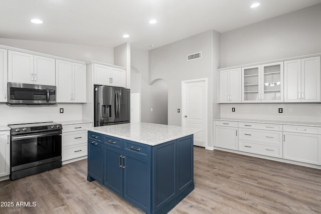 1015 E Penny Ln, San Tan Valley, AZ 85140 - kitchen with appliances with stainless steel finishes, blue cabinets, arched walkways, white cabinetry, and recessed lighting