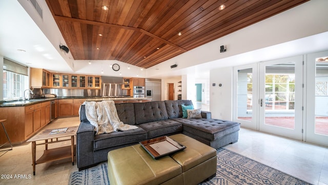 living room featuring high vaulted ceiling, wooden ceiling, and sink