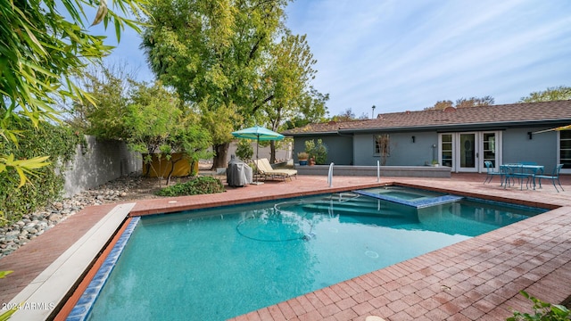 view of swimming pool with a patio area and an in ground hot tub