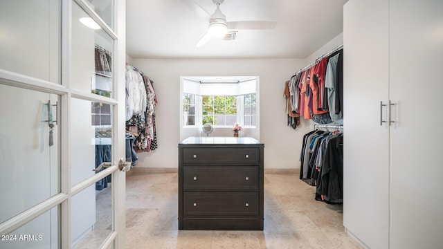 spacious closet with ceiling fan and french doors