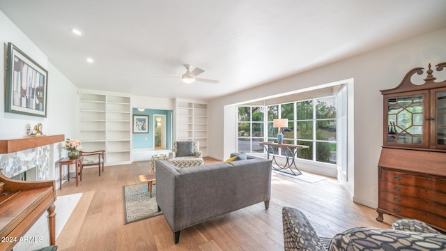 living room featuring light wood-type flooring and ceiling fan