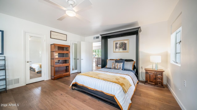 bedroom with wood-type flooring and ceiling fan