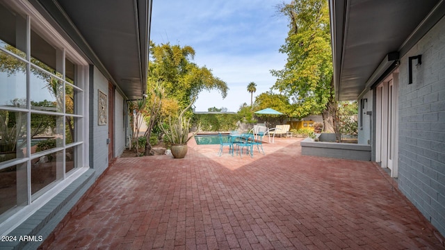 view of patio featuring a fenced in pool