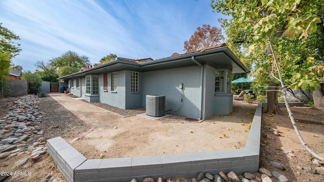 view of side of home featuring central AC