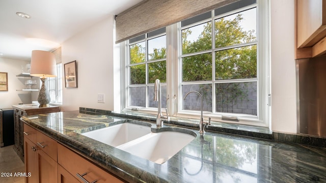 kitchen with sink and dark stone counters