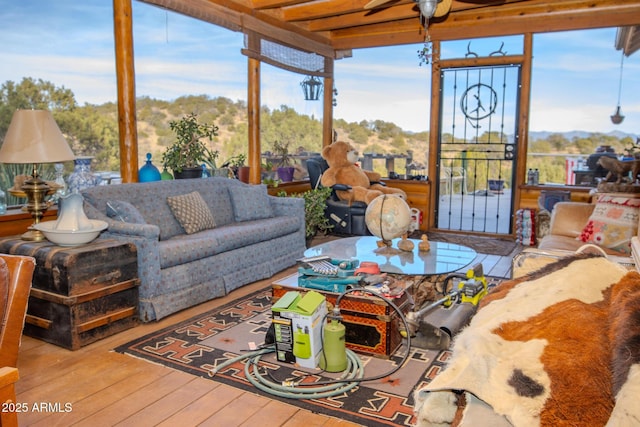 sunroom / solarium featuring ceiling fan