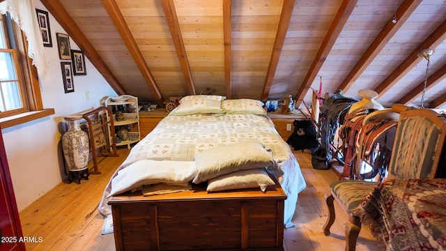 bedroom featuring wooden ceiling, light wood-type flooring, and beam ceiling