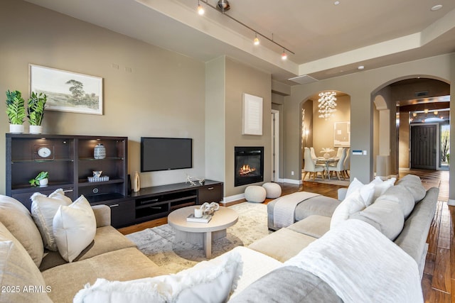 living room featuring track lighting and wood-type flooring