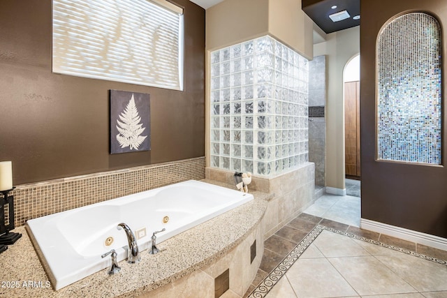 bathroom featuring tile patterned floors and independent shower and bath