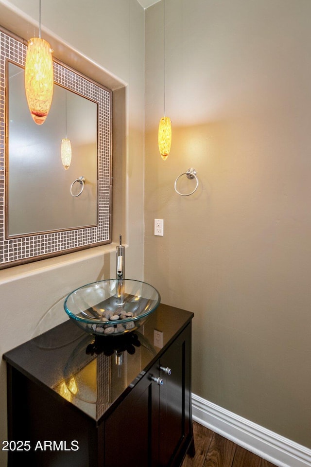 bathroom featuring hardwood / wood-style flooring and vanity