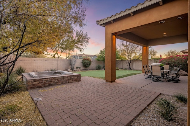 view of patio terrace at dusk