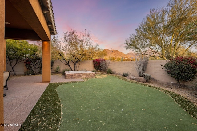 yard at dusk with a patio