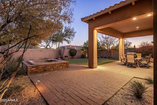 view of patio terrace at dusk