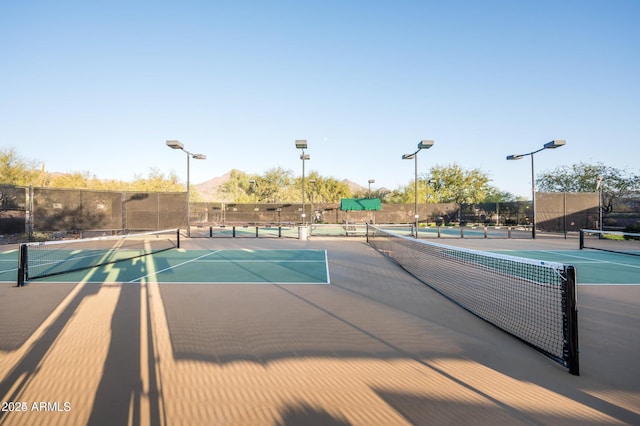 view of tennis court featuring a mountain view