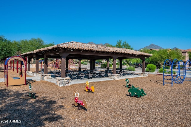 view of community with a gazebo, a playground, and a mountain view