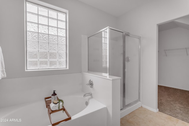 bathroom featuring shower with separate bathtub, tile patterned flooring, and a wealth of natural light