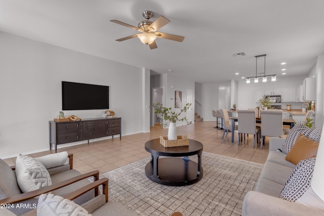 tiled living room with ceiling fan