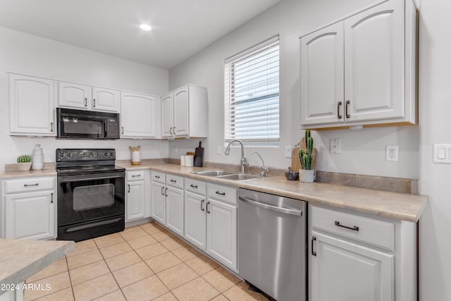 kitchen featuring sink, white cabinets, black appliances, and light tile patterned floors