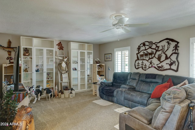 living room with a textured ceiling, light carpet, ceiling fan, and french doors