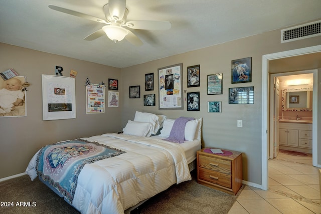 tiled bedroom featuring ceiling fan and connected bathroom