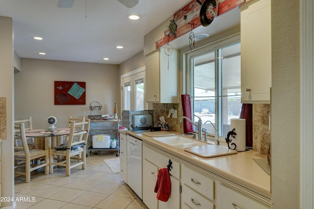 kitchen featuring decorative backsplash, light tile patterned floors, white dishwasher, ceiling fan, and sink