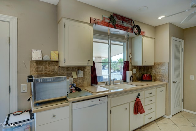 kitchen featuring ceiling fan, white dishwasher, decorative backsplash, and white cabinetry