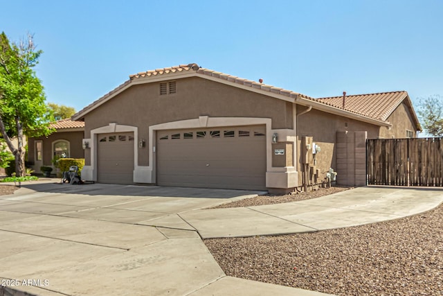 13609 W Vermont Ave, Litchfield Park, AZ 85340 - view of front of home with stucco siding, an attached garage, a tile roof, and concrete driveway
