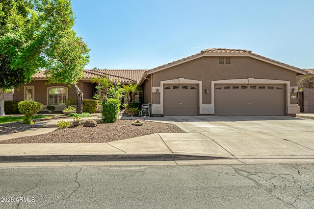 13609 W Vermont Ave, Litchfield Park, AZ 85340 - mediterranean / spanish home with stucco siding, a tile roof, a garage, and driveway