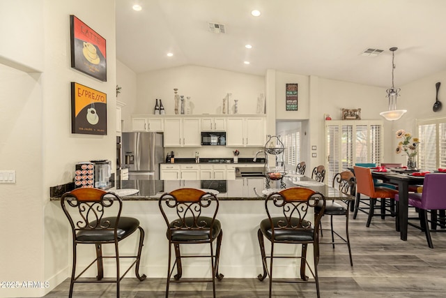 13609 W Vermont Ave, Litchfield Park, AZ 85340 - kitchen featuring white cabinetry, stainless steel refrigerator with ice dispenser, black microwave, and visible vents