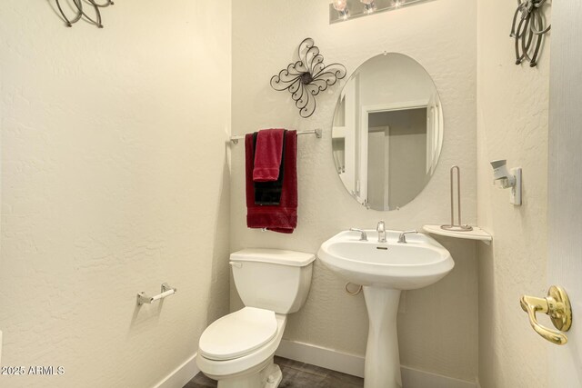 13609 W Vermont Ave, Litchfield Park, AZ 85340 - half bathroom with toilet, baseboards, and wood finished floors