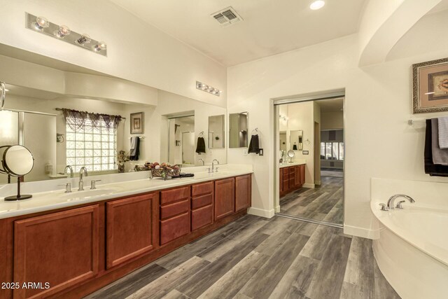 13609 W Vermont Ave, Litchfield Park, AZ 85340 - full bath with double vanity, visible vents, wood finished floors, and a sink